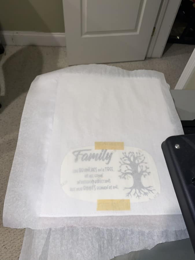 sublimation image towel covered with parchment paper on heat press